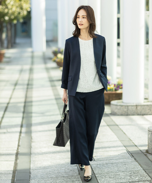 リネンライクカラーレスジャケット【セットアップ対応】、リネンライクワイドパンツ【セットアップ対応】、レースドッキングプルオーバーを着用した女性の画像（アンカーリンク）