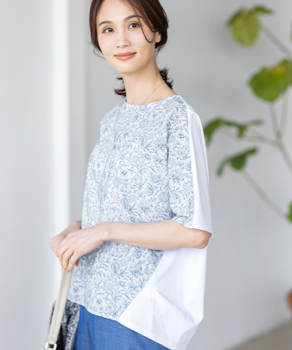 リバティプリントプルオーバー、デニムライクストレッチワイドパンツ、リバティプリントワンショルダーバッグを着用した女性の画像（アンカーリンク）