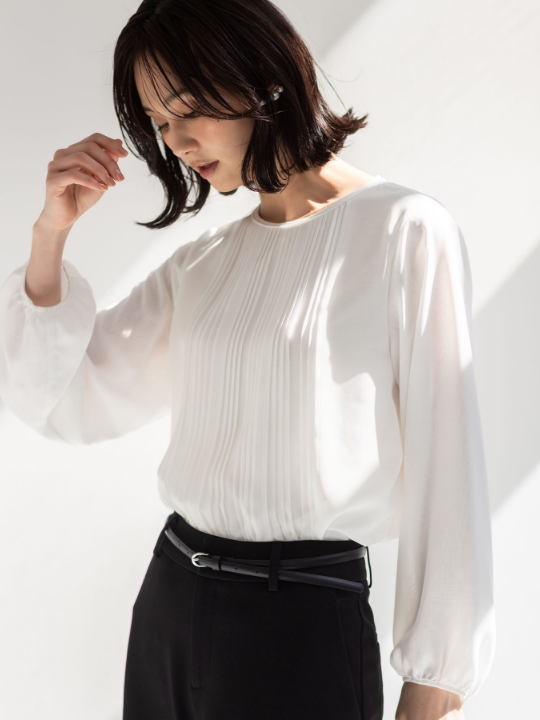 プリーツTブラウスを着用した女性