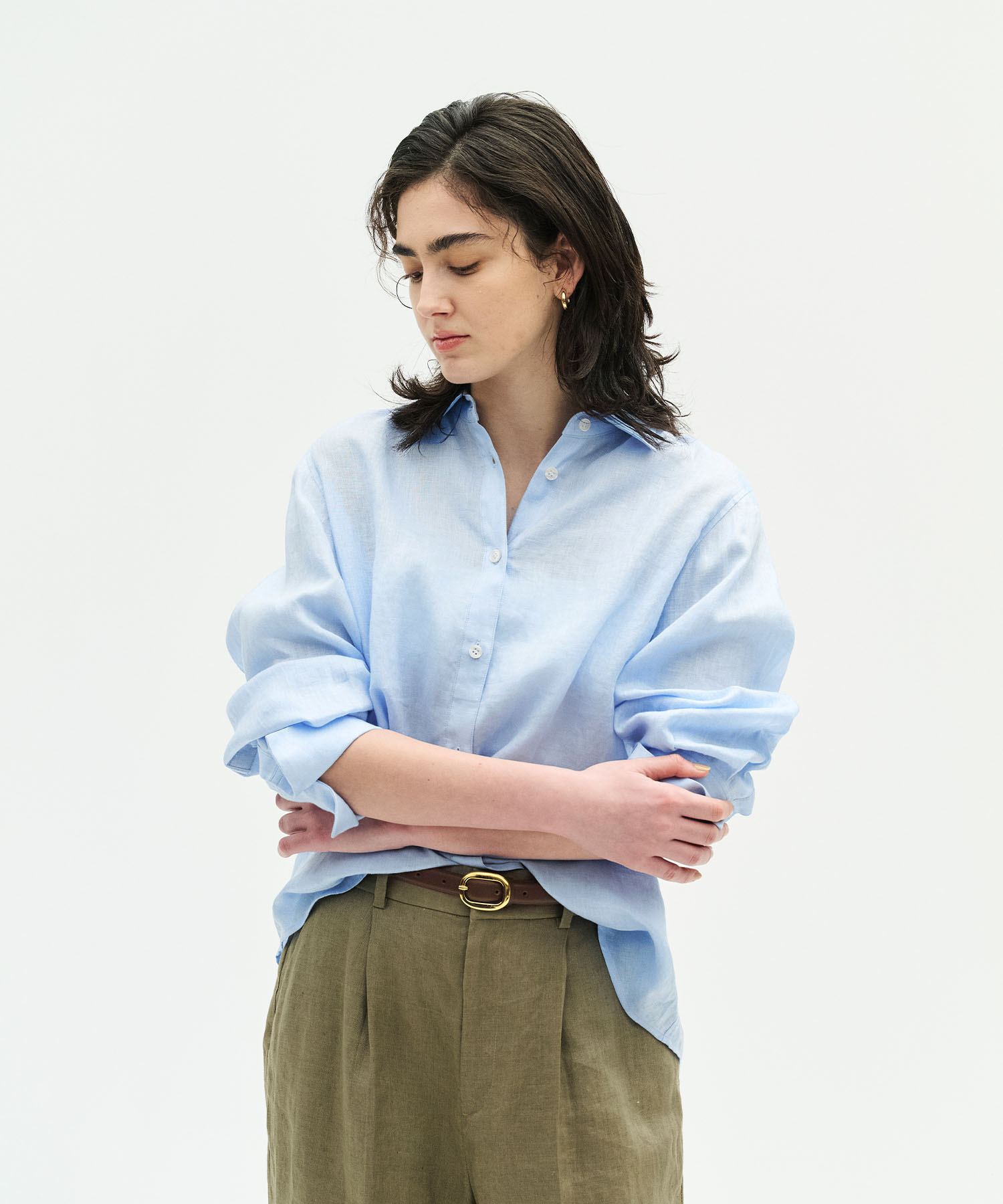 N.O.R.C パールモチーフブローチを着用した女性