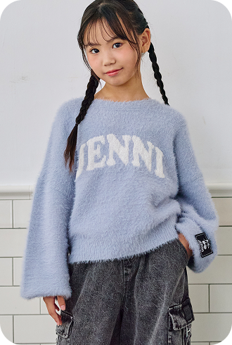 ブルーのJENNIロゴシャギーニットとブラックデニムを着た女の子