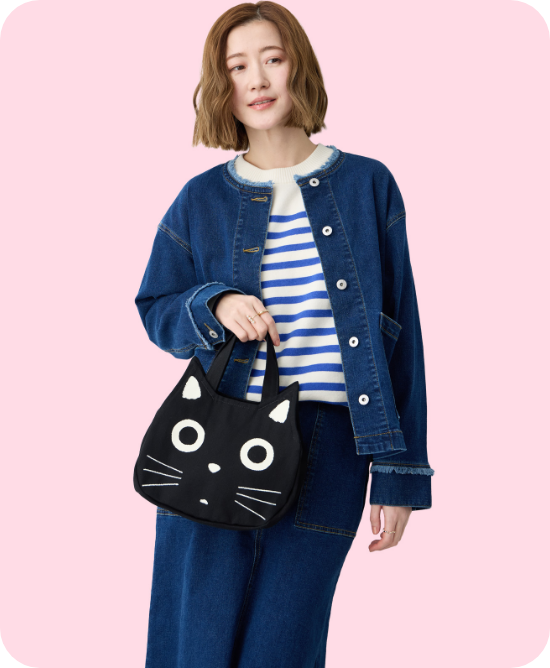 黒猫ミニフェイスバックを持った女性の写真