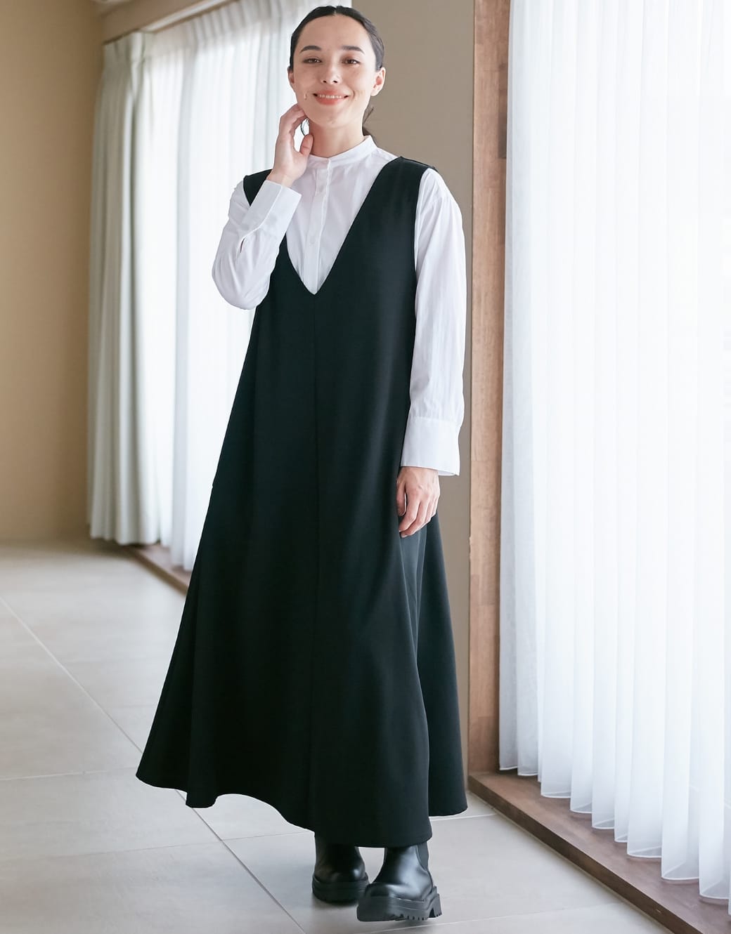 Vネックスムースワンピース／ジャンパースカートを着用している女性モデルの画像01