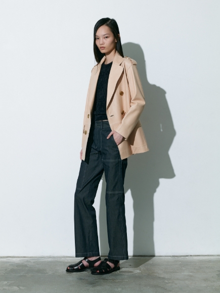 キャメルカラーのCoatと黒色のPullover、Pantsを着用している女性の画像