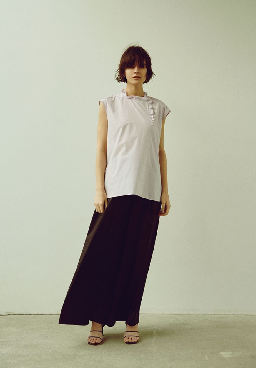 ホスタンド カラーフリル ブラウス、サテンワイド パンツを着用した女性の写真-1