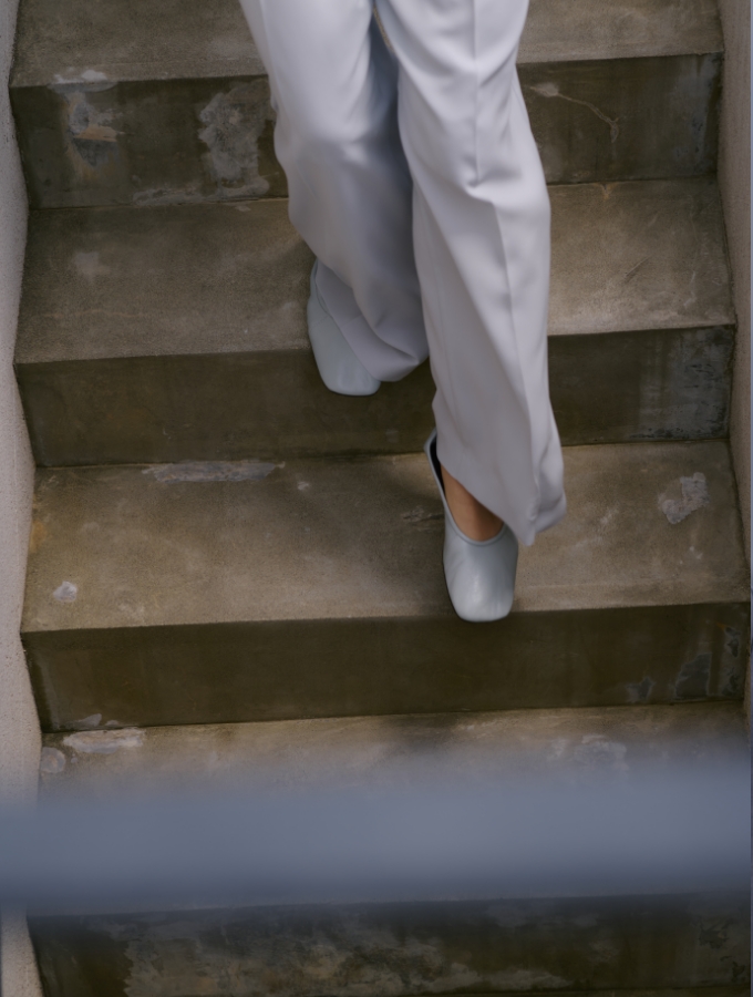 ネイビー色ピークドラペルダブルジャケット【CLEAN MOTION】とネイビーストライプのコンフォータブルシャツを着用した女性の画像